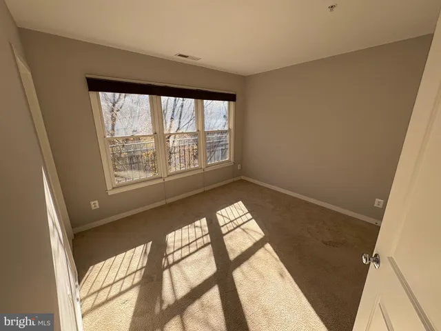 a view of an empty room with windows