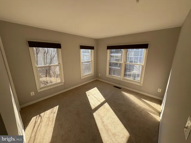a view of an empty room with windows