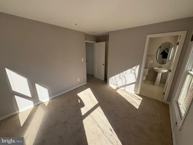 a view of a hallway to a livingroom with furniture