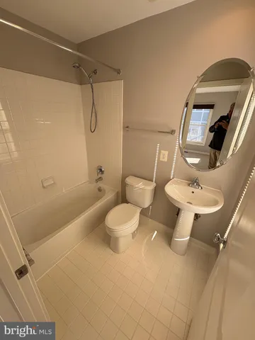 a bathroom with a toilet sink and shower