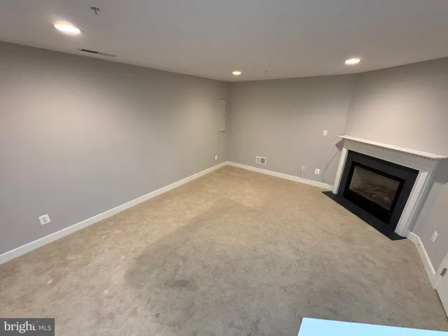 a view of an empty room with a fireplace