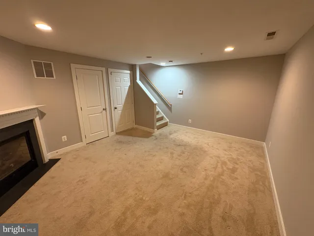 a view of empty room with a fireplace
