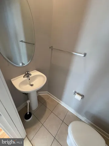 a bathroom with a sink toilet and mirror