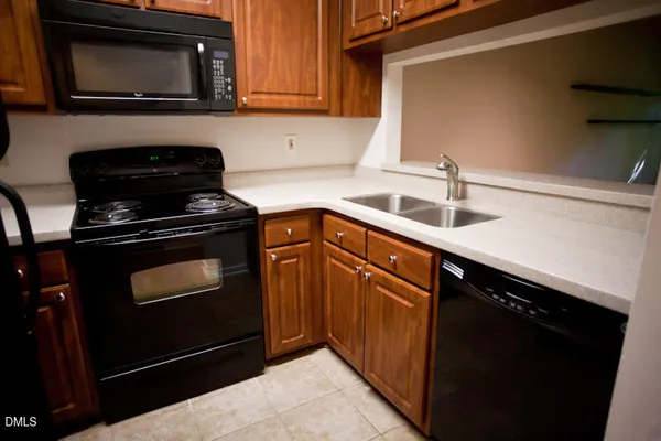 a kitchen with stainless steel appliances granite countertop a stove and a microwave