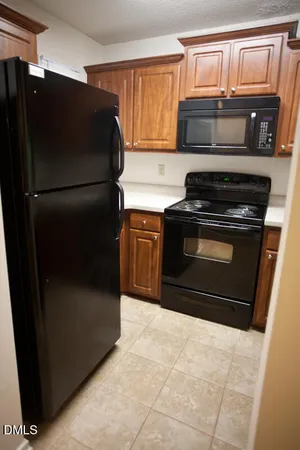 a stove top oven sitting inside of a kitchen