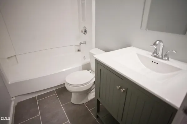 a bathroom with a toilet a sink and bathtub