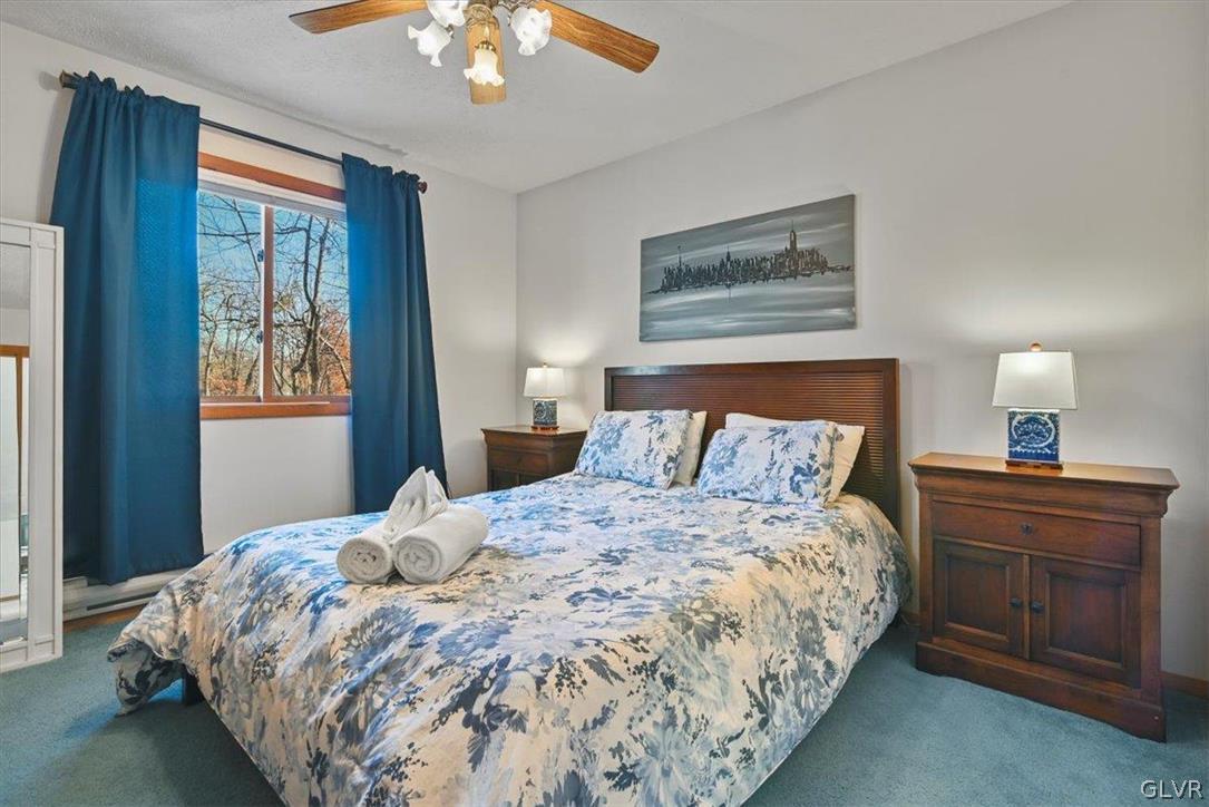 176 Stafford Drive Bushkill, PA 18324 - Photo 36 of 50 a bedroom with a large bed and a chandelier