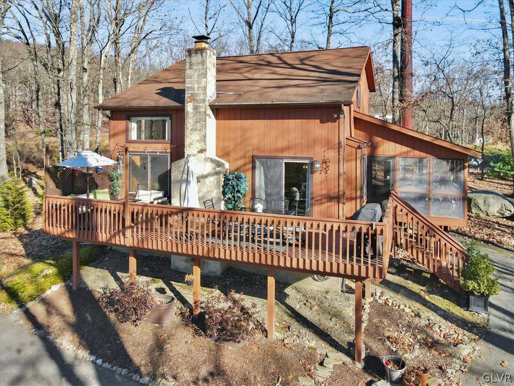 176 Stafford Drive Bushkill, PA 18324 - Photo 7 of 50 a view of a brick house with a wooden deck