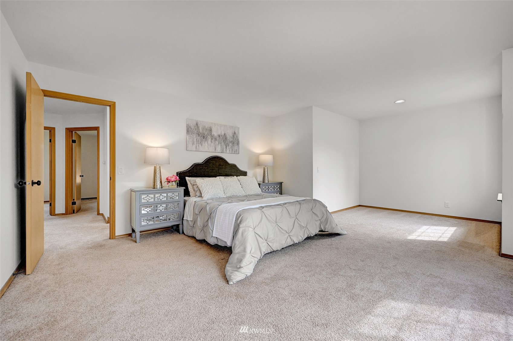 1422 243rd Place Southwest Bothell, WA 98021 - Photo 22 of 40 a spacious bedroom with a bed and a couch
