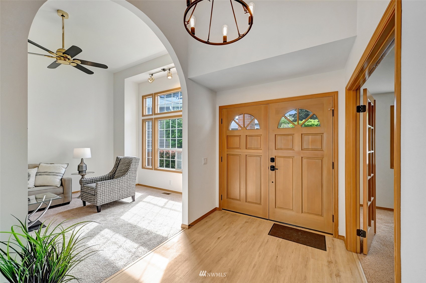 1422 243rd Place Southwest Bothell, WA 98021 - Photo 3 of 40 a spacious bedroom with a bed and a chandelier