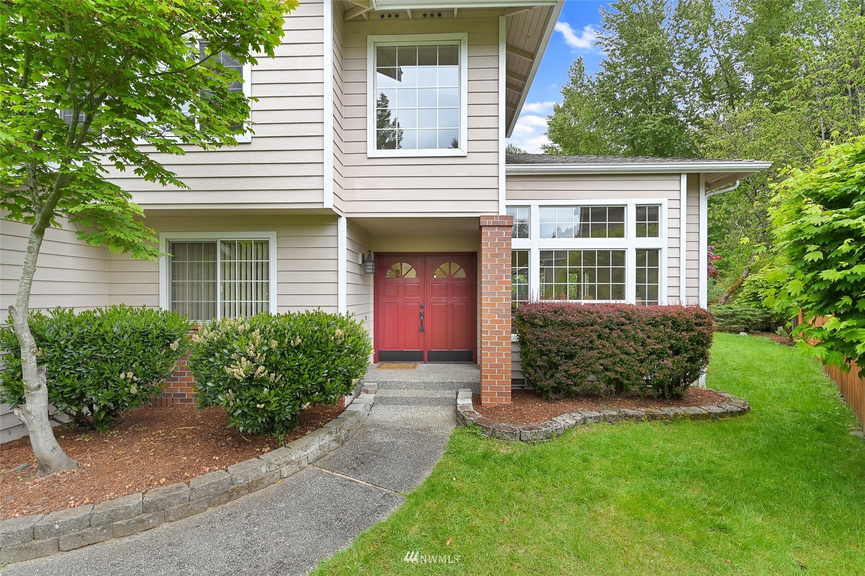 1422 243rd Place Southwest Bothell, WA 98021 - Photo 38 of 40 a front view of a house with a yard