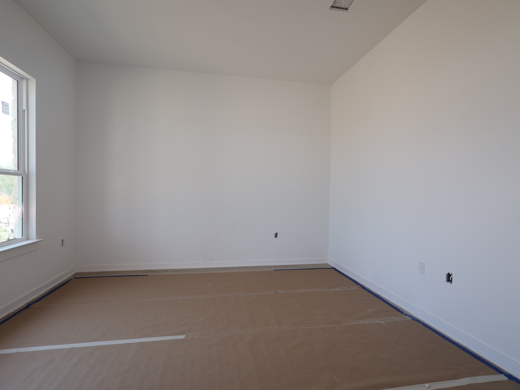 261 Callahan Loop Buda, TX 78610 - Photo 13 of 19 an empty room with a window