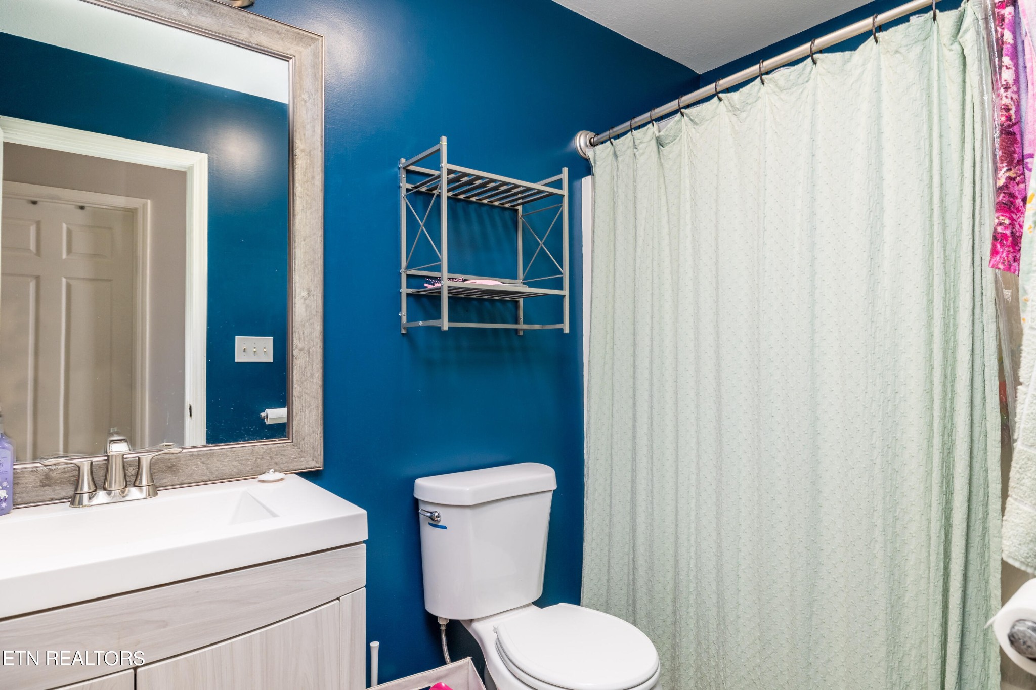 228 West Edison Street Alcoa, TN 37701 - Photo 18 of 24 a bathroom with a sink a toilet and shower curtain