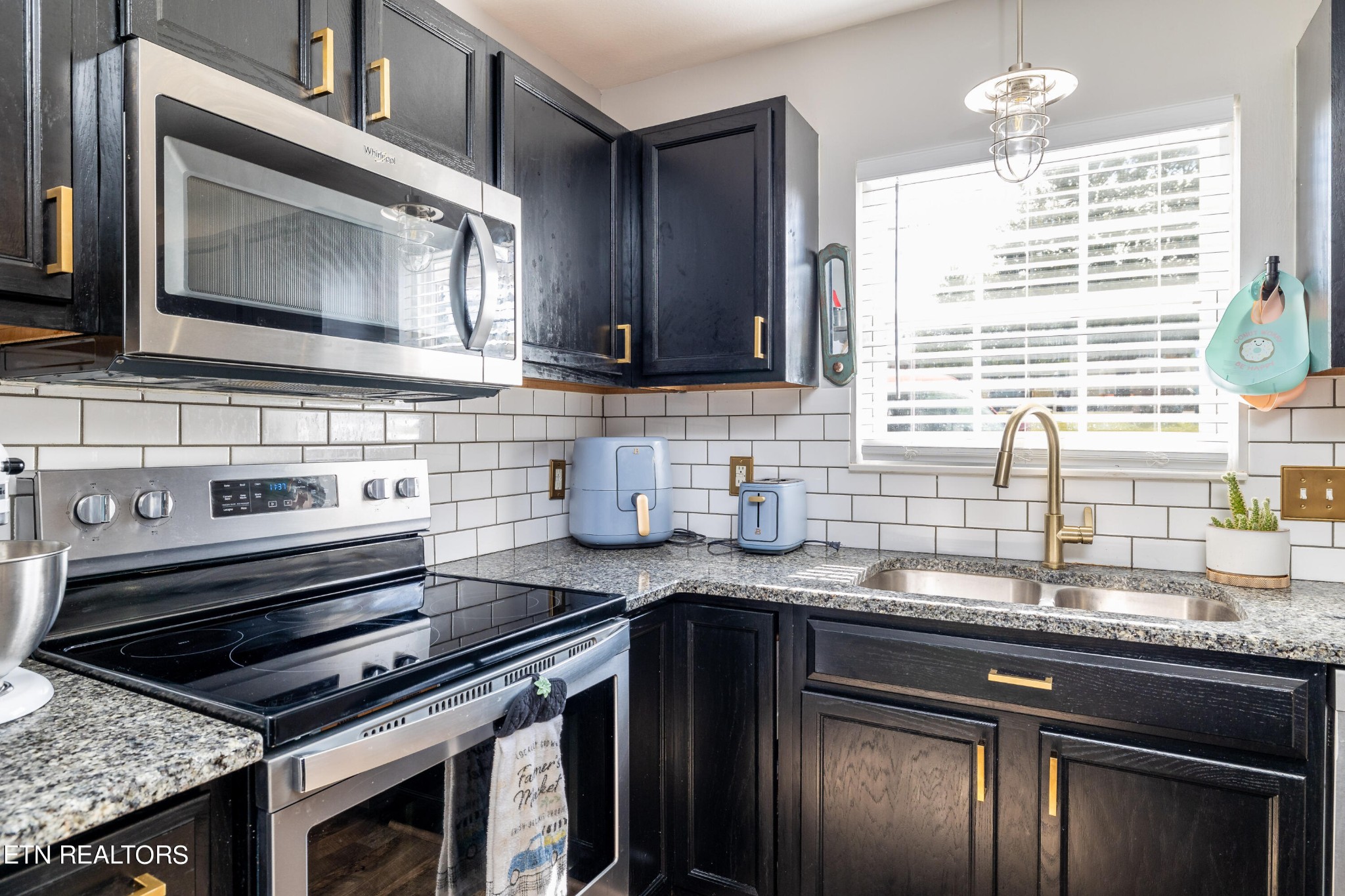 228 West Edison Street Alcoa, TN 37701 - Photo 8 of 24 a kitchen with granite countertop a sink stainless steel appliances and cabinets