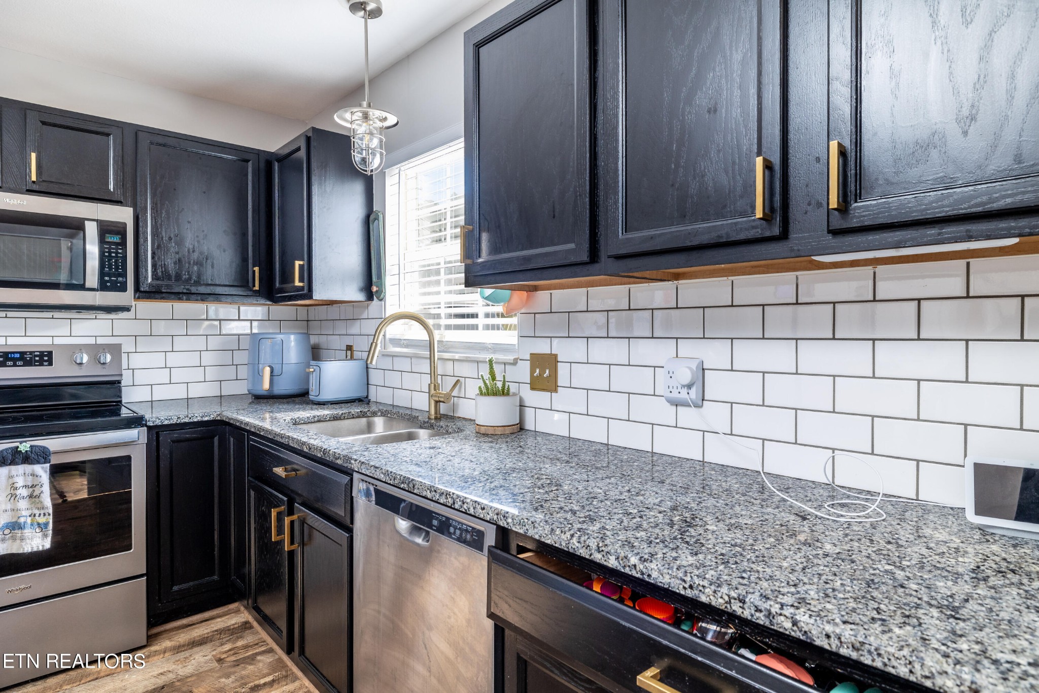 228 West Edison Street Alcoa, TN 37701 - Photo 9 of 24 a kitchen with granite countertop a sink a stove and cabinets