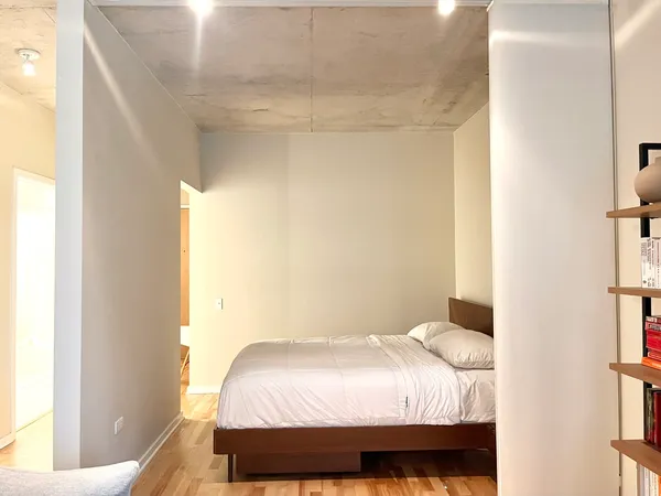 a bedroom with a bed and a window