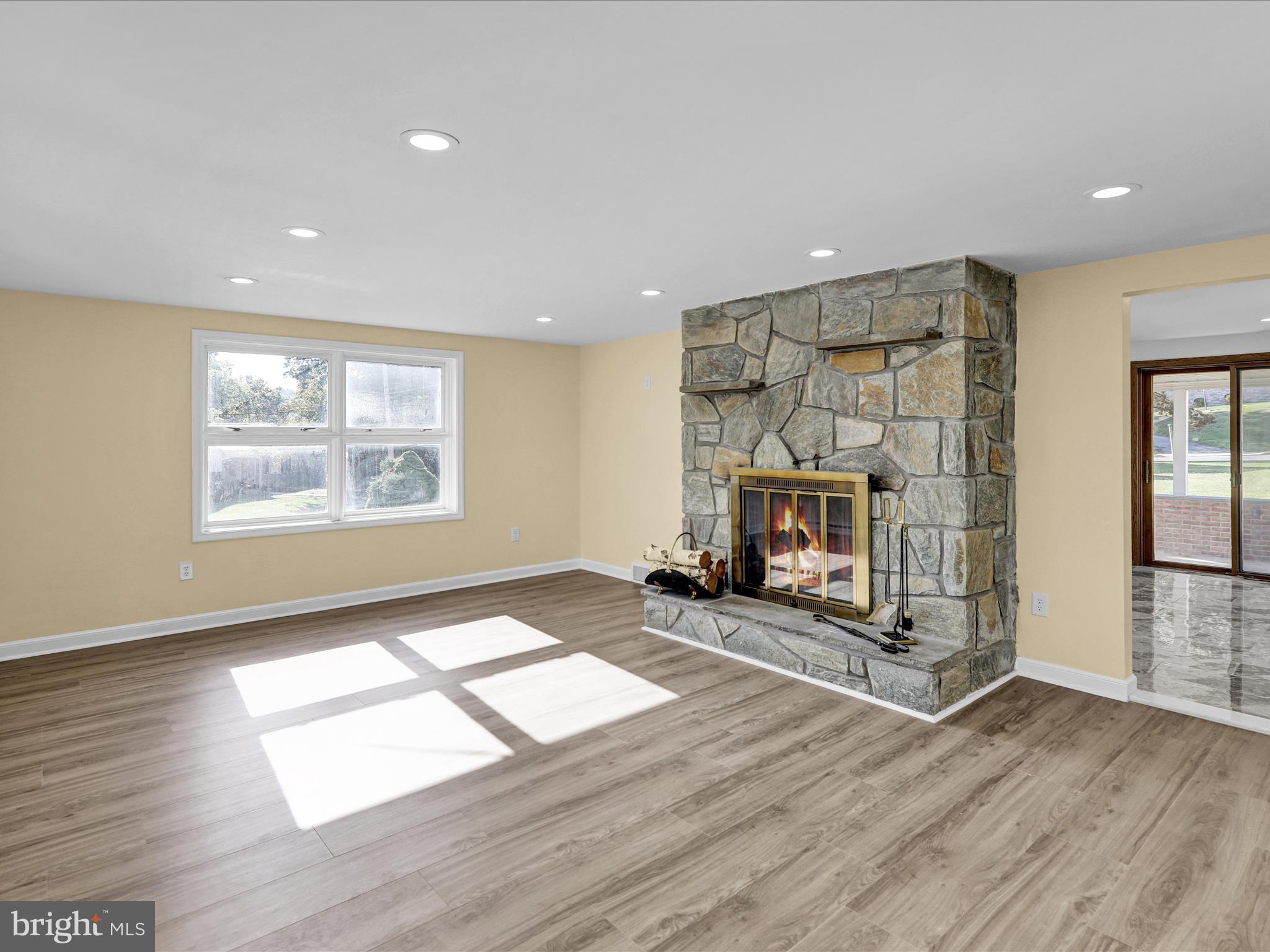 320 Hillside Drive Reading, PA 19607 - Photo 12 of 38 a view of an empty room with wooden floor fireplace and a window