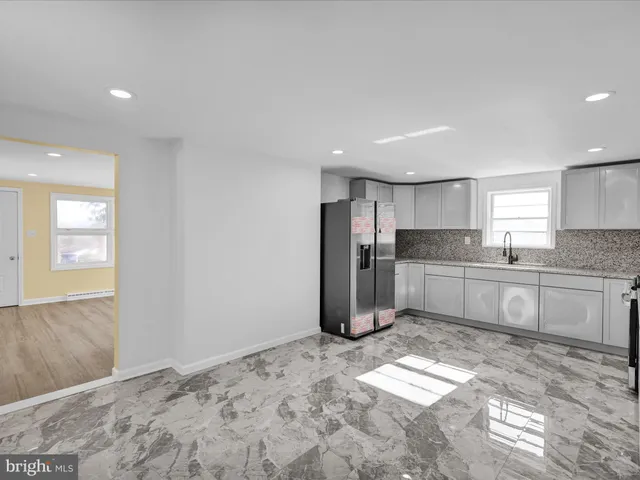 a kitchen with granite countertop a stove sink and cabinets