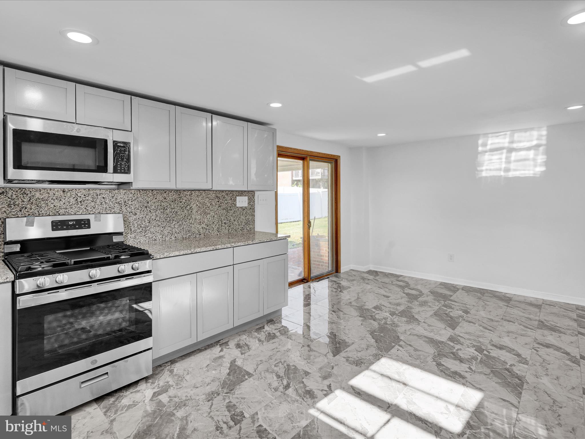 320 Hillside Drive Reading, PA 19607 - Photo 19 of 38 a kitchen with stainless steel appliances granite countertop a stove a sink and a microwave