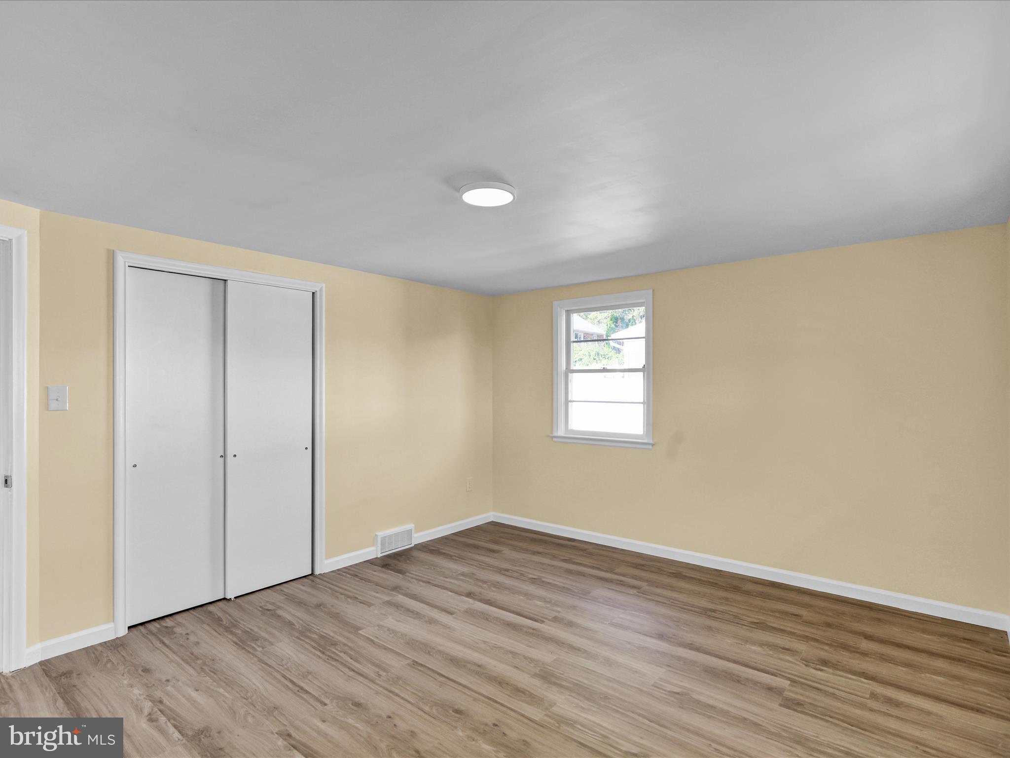 320 Hillside Drive Reading, PA 19607 - Photo 22 of 38 a view of an empty room with wooden floor and a window
