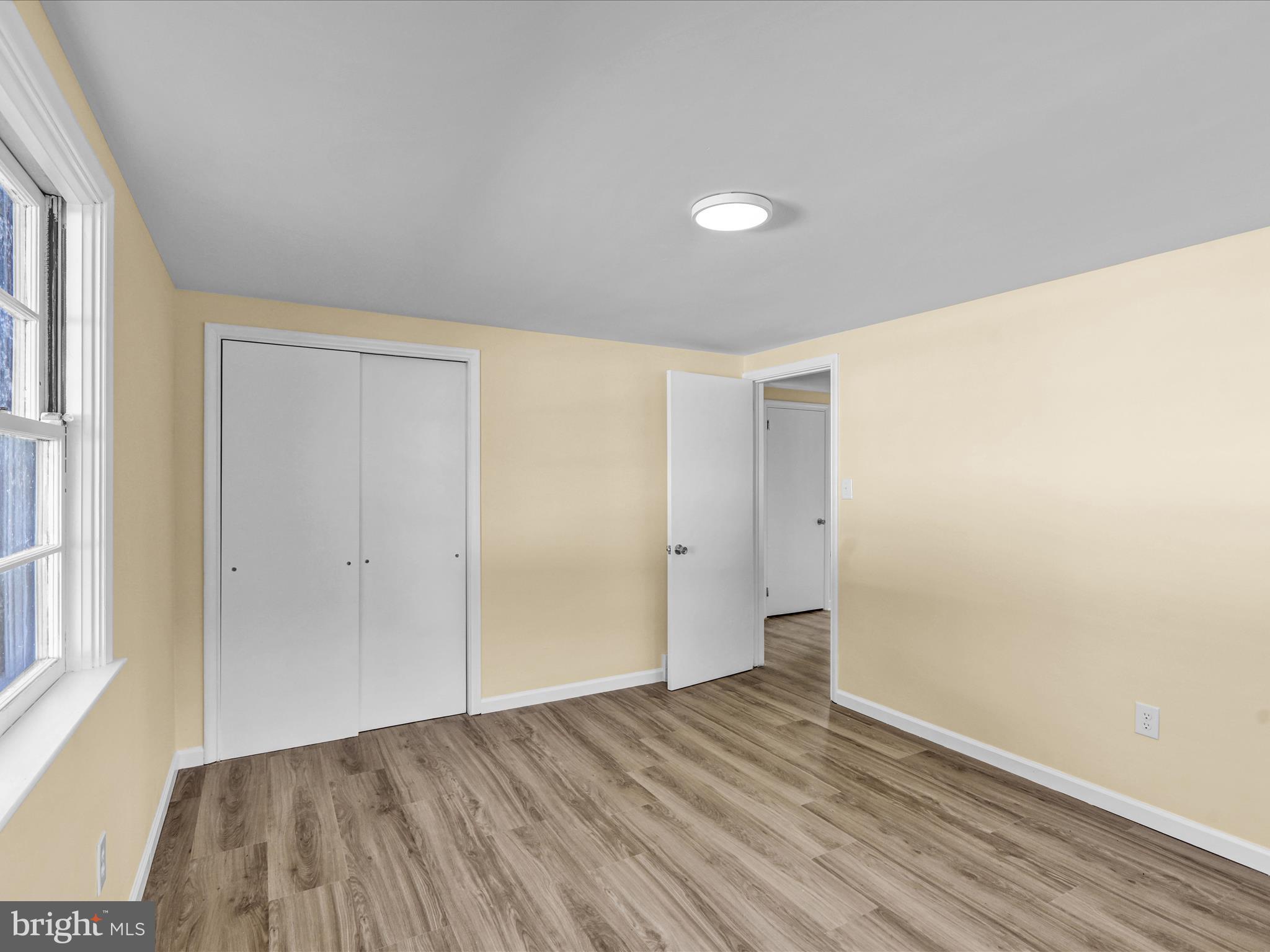 320 Hillside Drive Reading, PA 19607 - Photo 24 of 38 a view of an empty room with wooden floor and a window