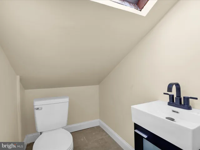 a view of a room with wooden floor and white walls