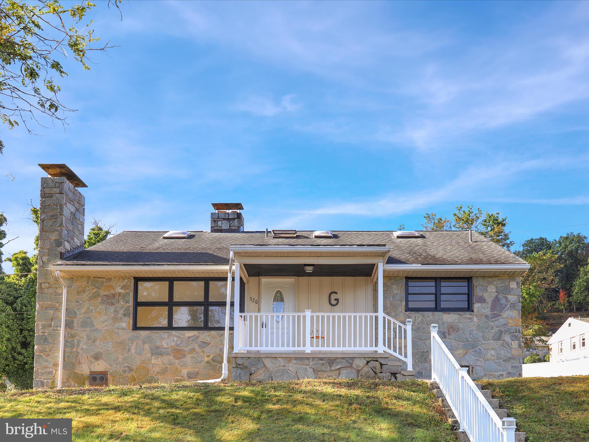 320 Hillside Drive Reading, PA 19607 - Photo 3 of 38 a view of a big house with a big yard and large tree