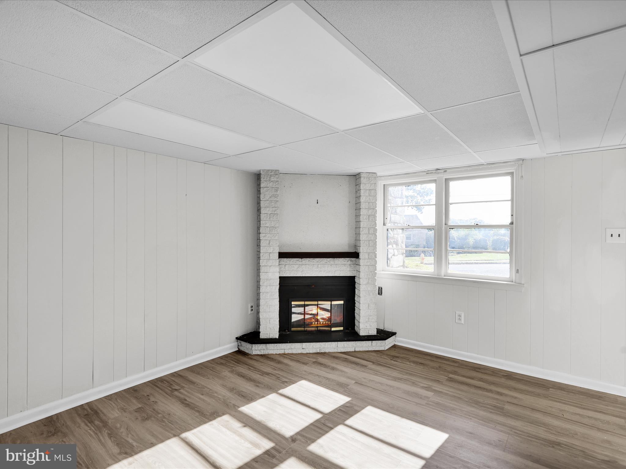 320 Hillside Drive Reading, PA 19607 - Photo 35 of 38 an empty room with wooden floor fireplace and window