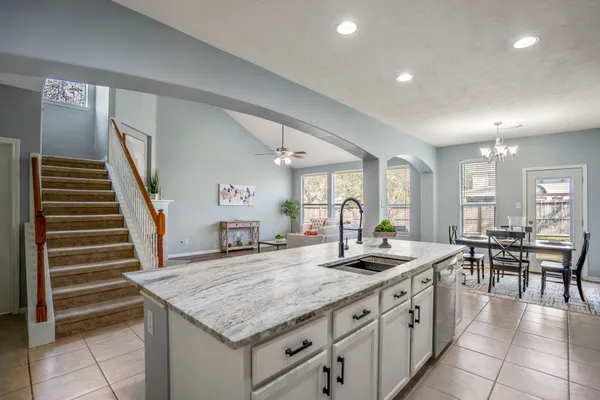 a kitchen with sink stove and cabinets