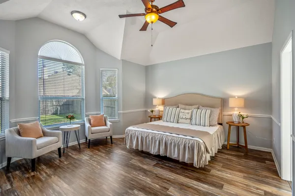 a bedroom with a bed and a chandelier