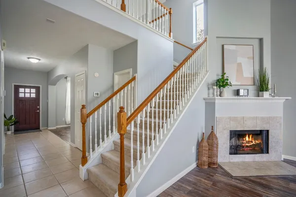 a view of a livingroom with wooden floor a fireplace