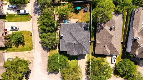 an aerial view of multiple houses with yard