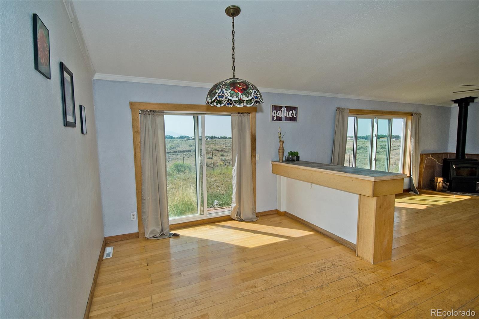 1372 North Saddlerock Trail Crestone, CO 81131 - Photo 15 of 43 a bedroom with a bed and a chandelier