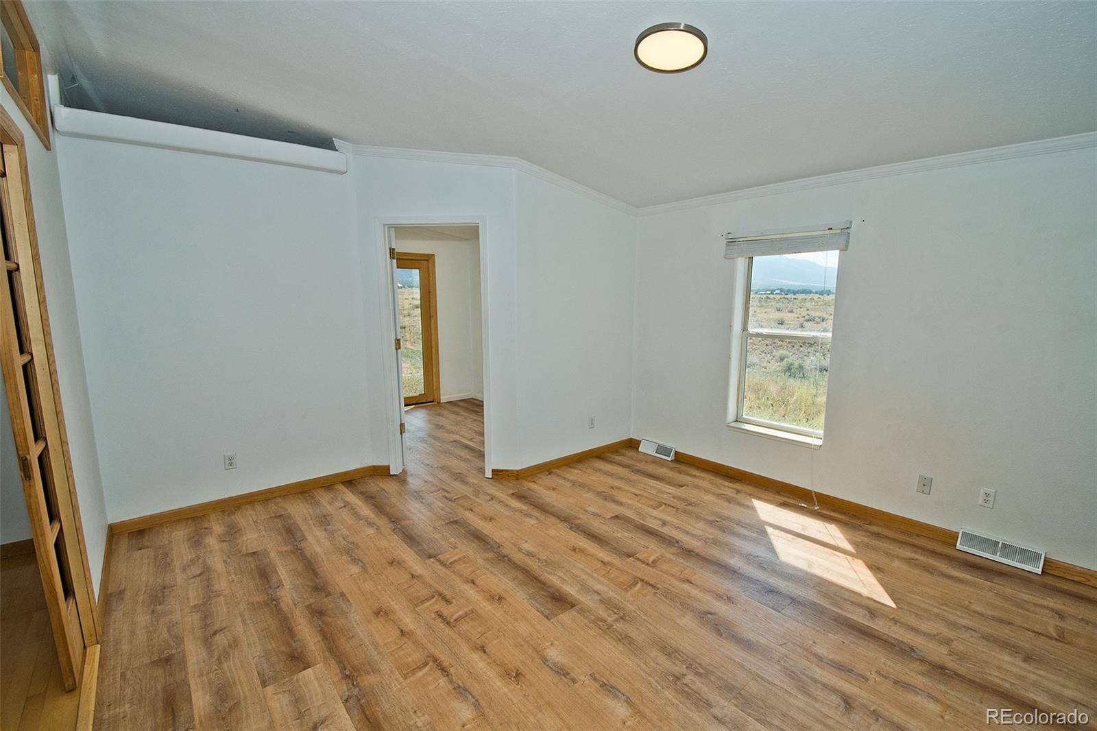 1372 North Saddlerock Trail Crestone, CO 81131 - Photo 22 of 43 an empty room with windows