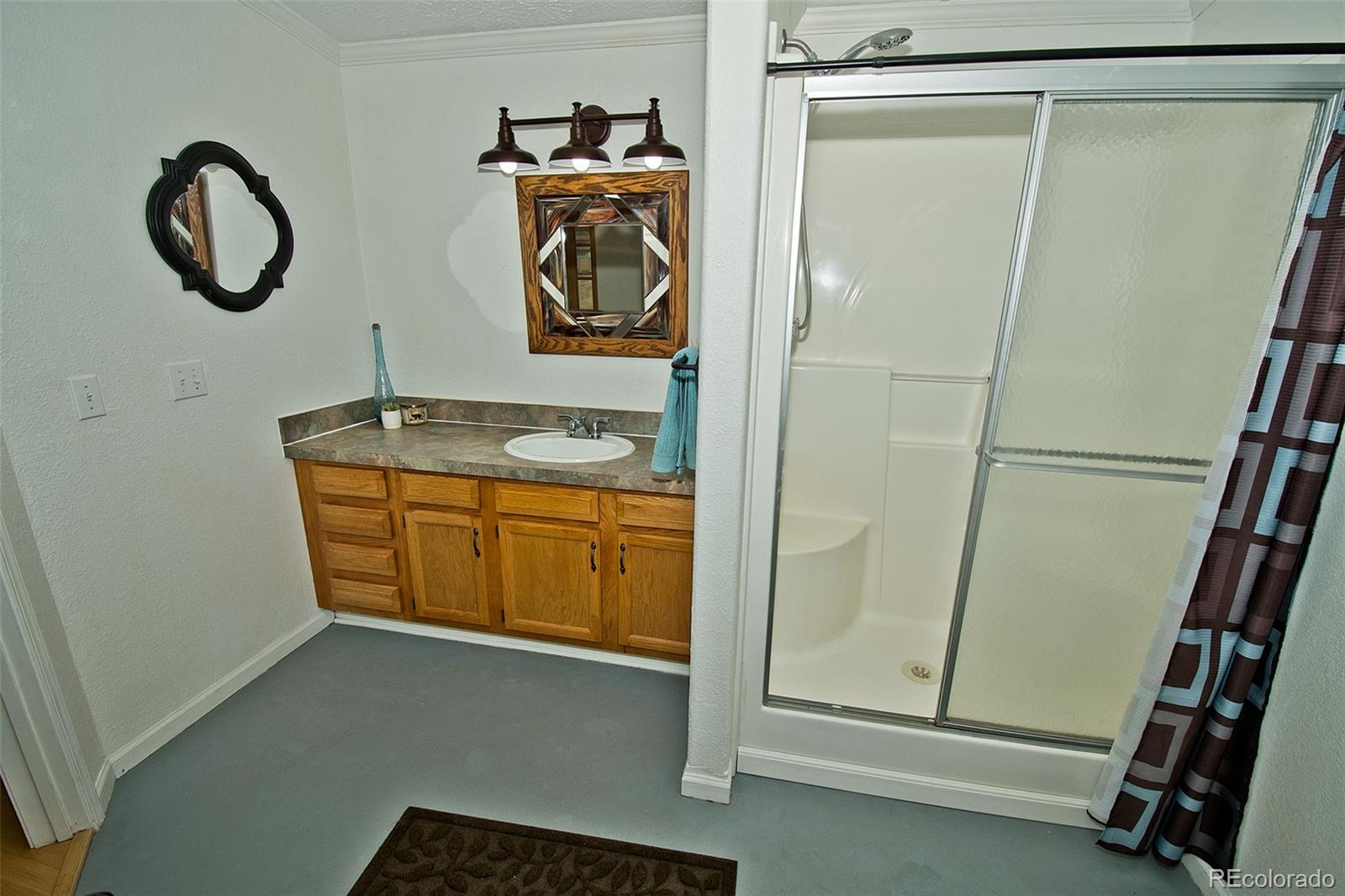 1372 North Saddlerock Trail Crestone, CO 81131 - Photo 30 of 43 a bathroom with a granite countertop sink and a mirror