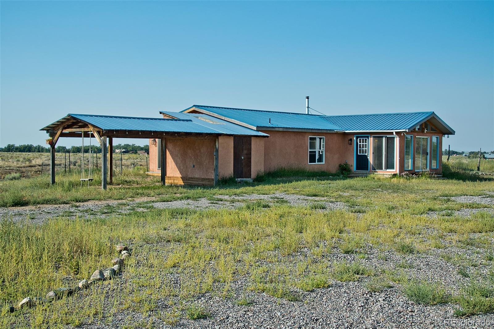 1372 North Saddlerock Trail Crestone, CO 81131 - Photo 4 of 43 a front view of a house with a yard