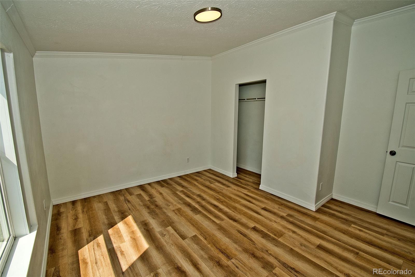 1372 North Saddlerock Trail Crestone, CO 81131 - Photo 41 of 43 a view of an empty room and wooden floor