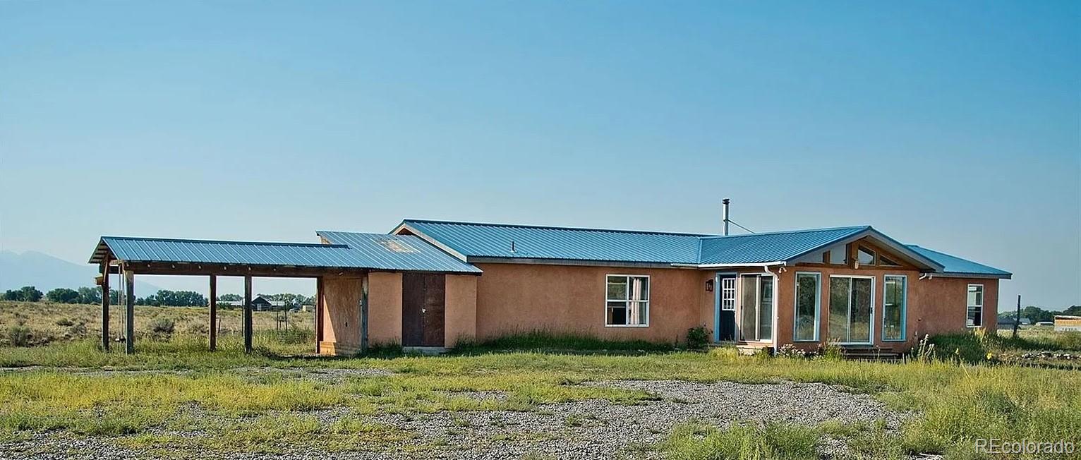 1372 North Saddlerock Trail Crestone, CO 81131 - Photo 7 of 43 a front view of a house with a yard