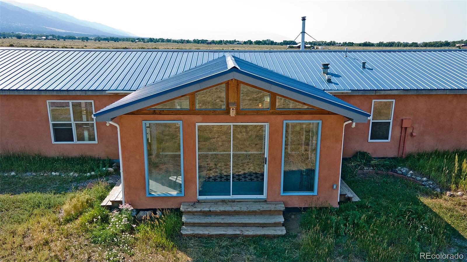 1372 North Saddlerock Trail Crestone, CO 81131 - Photo 9 of 43 a front view of a house with garden