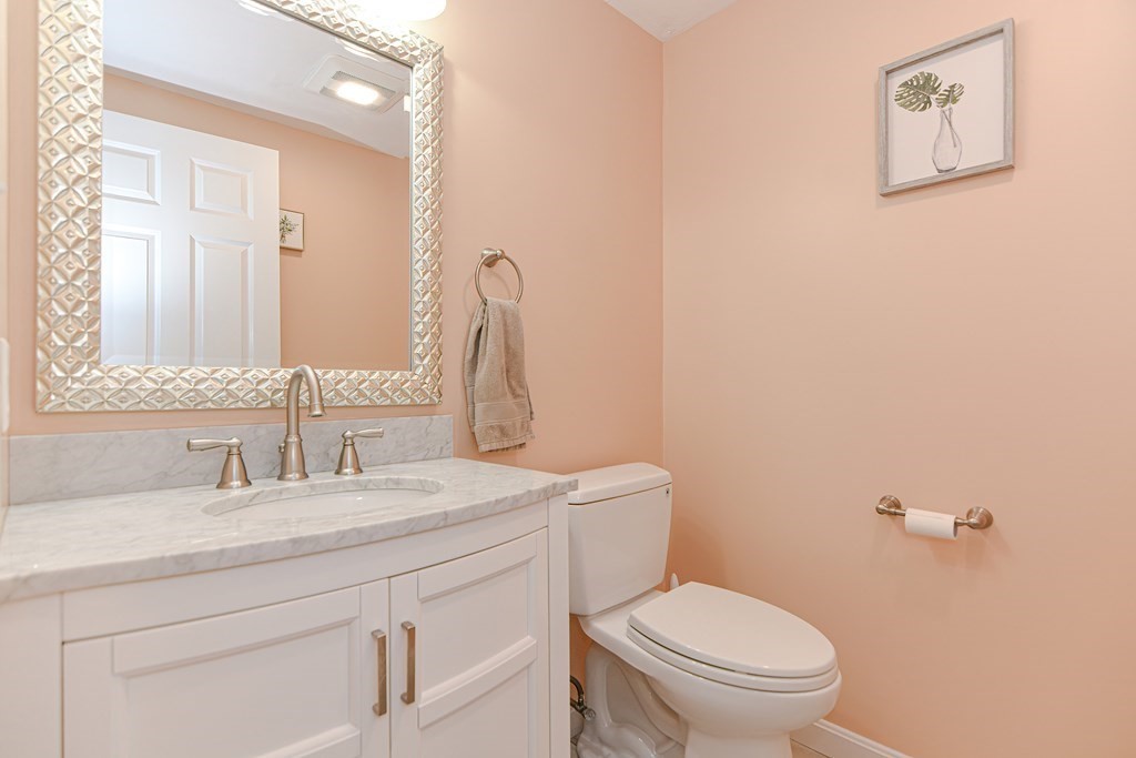 41 Boston Road, Unit 351 Billerica, MA 01862 - Photo 13 of 25 a bathroom with a toilet sink vanity and mirror