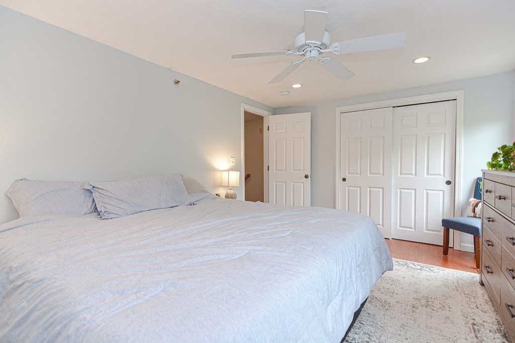 41 Boston Road, Unit 351 Billerica, MA 01862 - Photo 15 of 25 a bedroom with a large bed and a chandelier