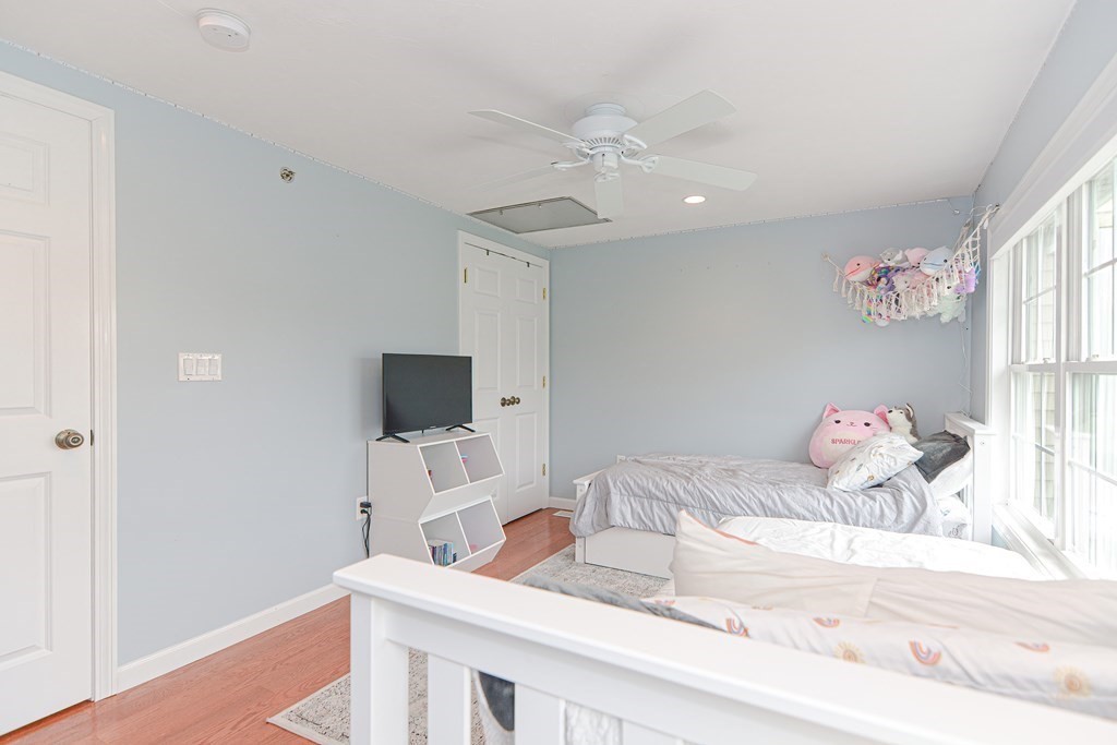 41 Boston Road, Unit 351 Billerica, MA 01862 - Photo 17 of 25 a bedroom with a bed and a chandelier