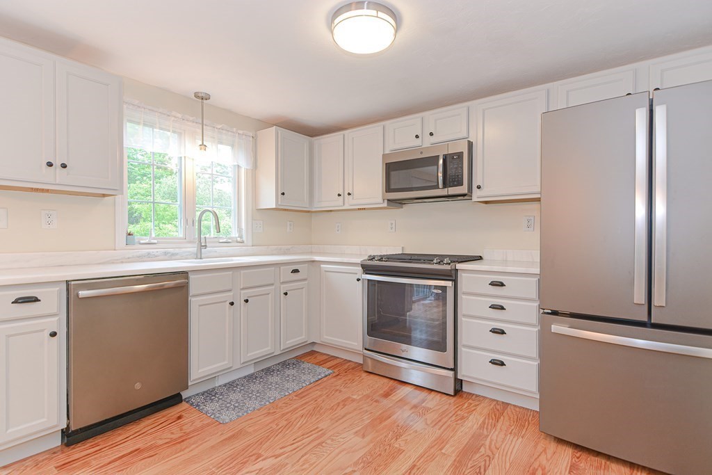 41 Boston Road, Unit 351 Billerica, MA 01862 - Photo 4 of 25 a kitchen with stainless steel appliances white cabinets and a window