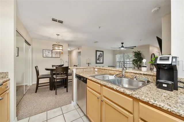 a kitchen with sink refrigerator and cabinets
