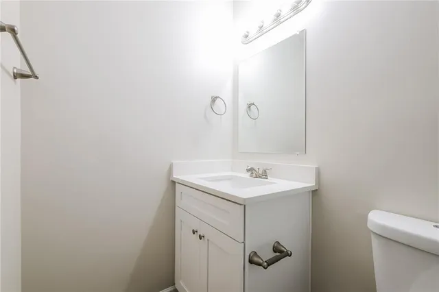 a white toilet sitting next to a bath tub