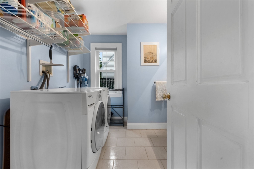 83 Payson Road Brookline, MA 02467 - Photo 12 of 34 a view of a hallway with washer and dryer