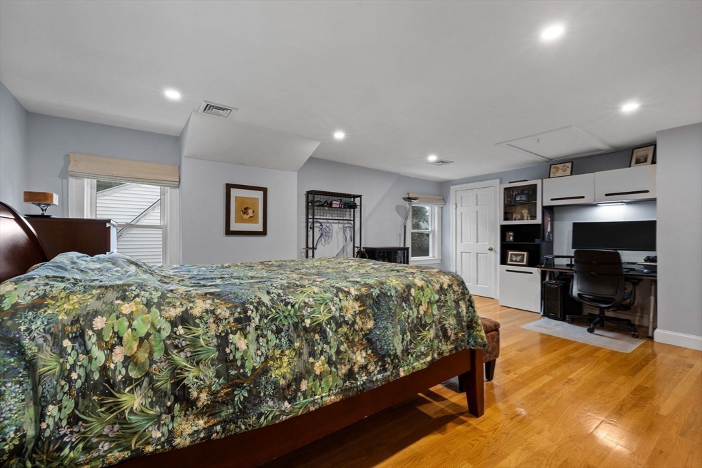 83 Payson Road Brookline, MA 02467 - Photo 16 of 34 a spacious bedroom with a large bed and a flat screen tv