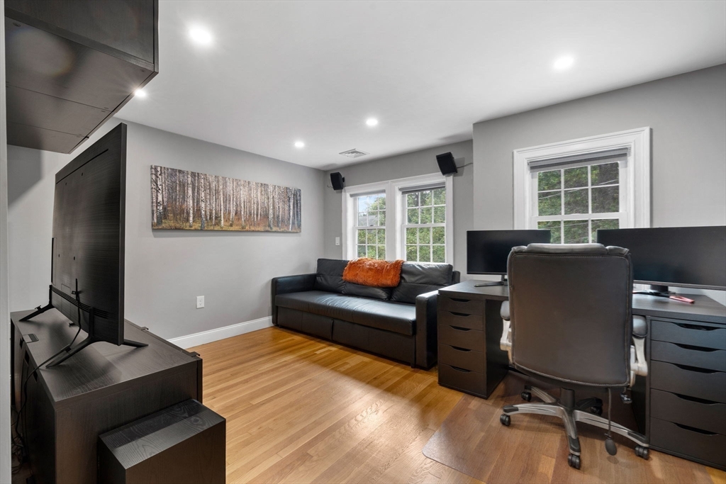 83 Payson Road Brookline, MA 02467 - Photo 24 of 34 a living room with furniture and a flat screen tv