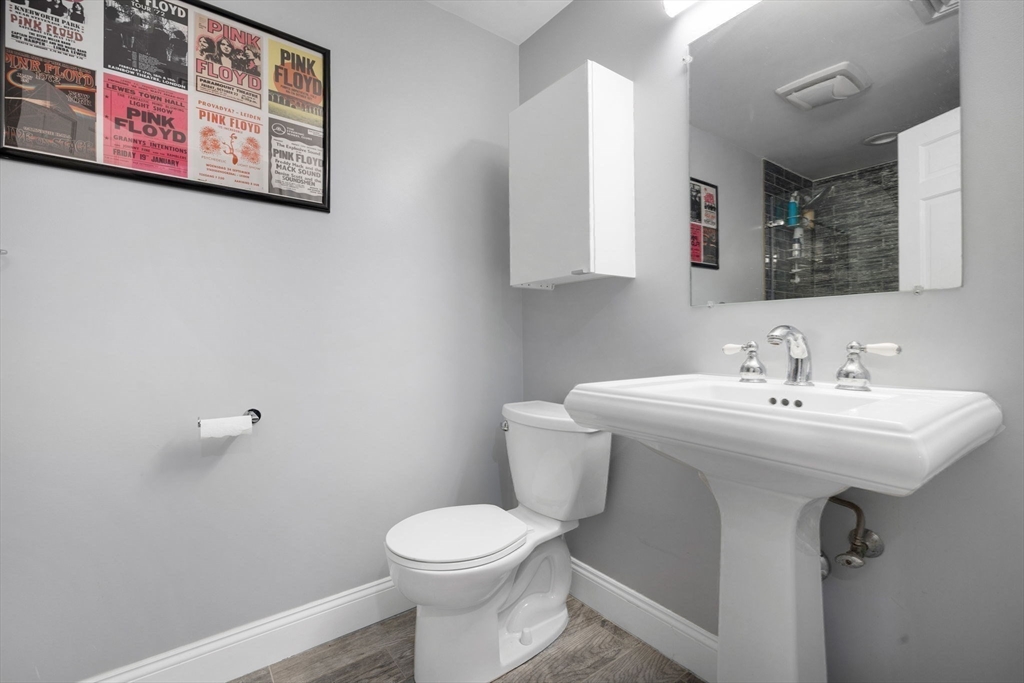 83 Payson Road Brookline, MA 02467 - Photo 26 of 34 a bathroom with a sink and mirror with toilet