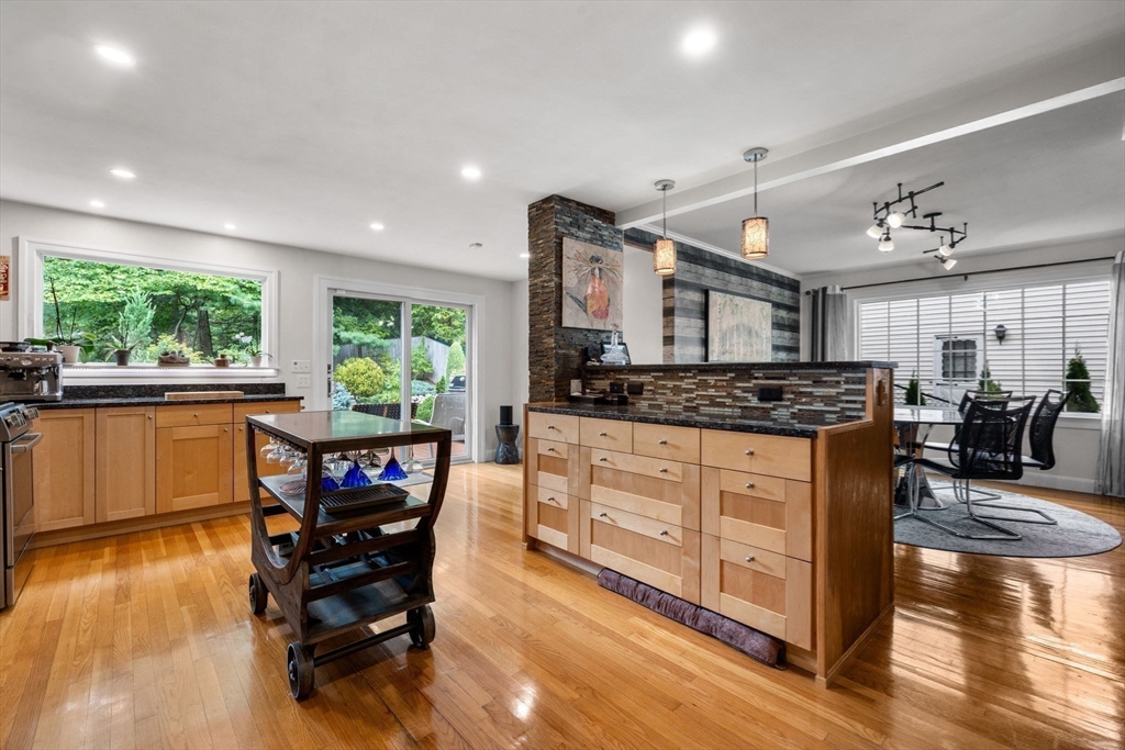 83 Payson Road Brookline, MA 02467 - Photo 3 of 34 a kitchen with stainless steel appliances granite countertop a stove and a wooden floors